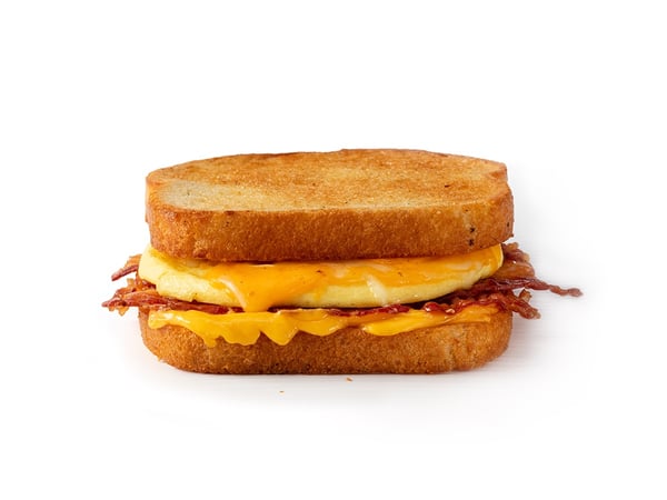 A grilled cheese sandwich with egg and bacon