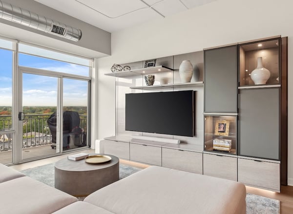 Living room entertainment center with media storage in light wood finish by California Closets Greater Detroit, Michigan.