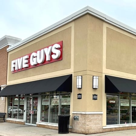 An exterior photograph of the Five Guys restaurant at 3732 Innes Road in Orleans, Ontario, Canada.