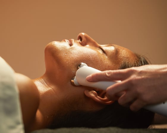 woman recieving microcurrent facial