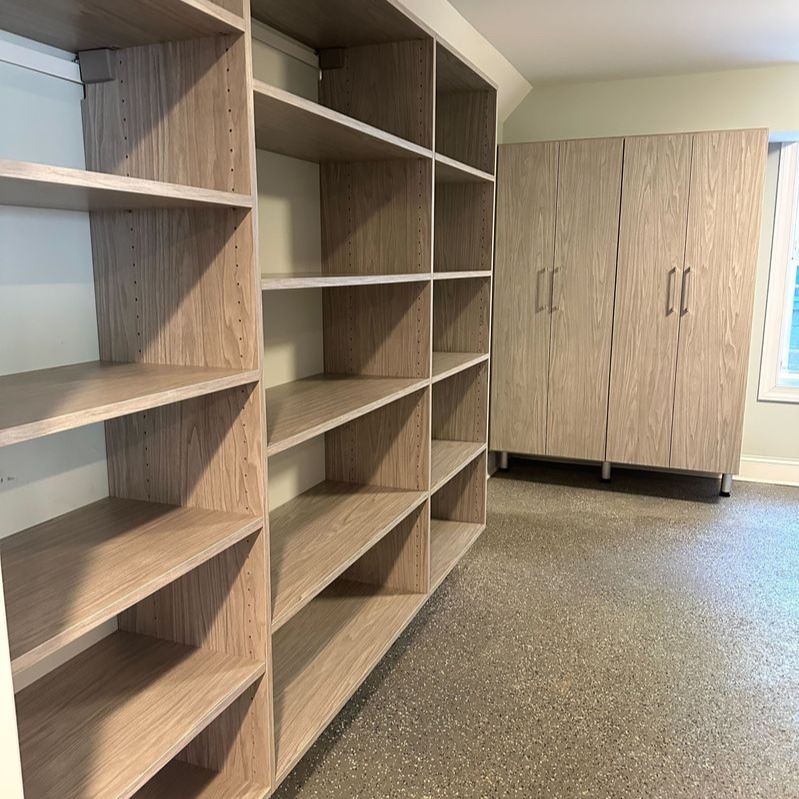 Greensboro - Custom closets - garage storage system with open wood shelving and tall cabinets on a polished concrete floor
