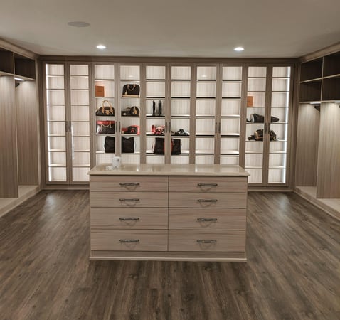 Luxe walk-in closet with backlit shoe shelving and center island