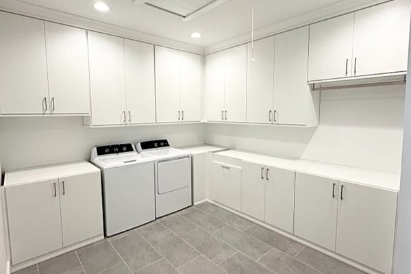 Cabinets for laundry room with hidden hamper baskets California Closets Pensacola & Panama City, Florida