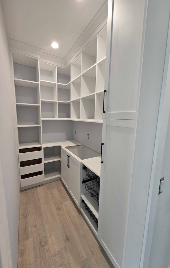 custom walk in pantry with white wood, shelves and cabinets