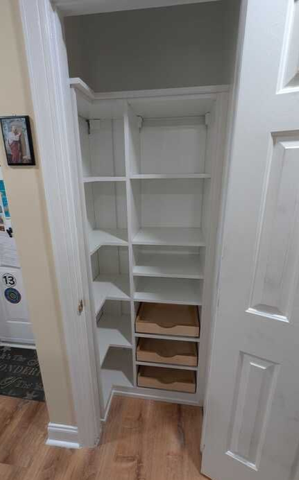 Virginia Beach - Custom closets - Small reach-in closet with angled shelving and pull-out drawers.