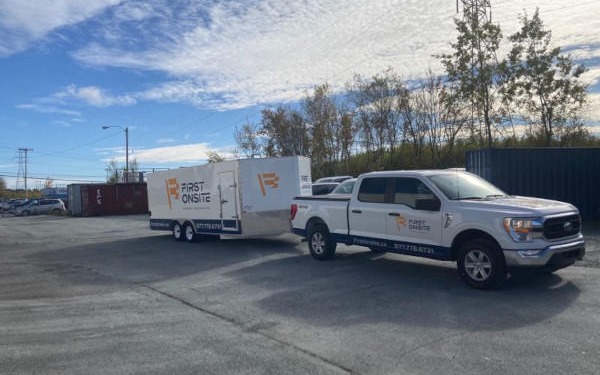 Truck and trailer ready for large-scale operations in open area.