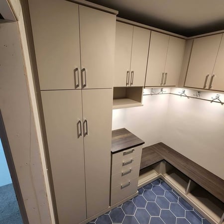 A walk-in closet with enclosed wardrobes and wrap-around floor shelving.