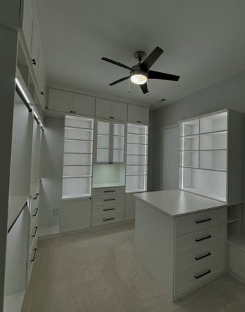 White walk-in closet with adjustable lighting.
