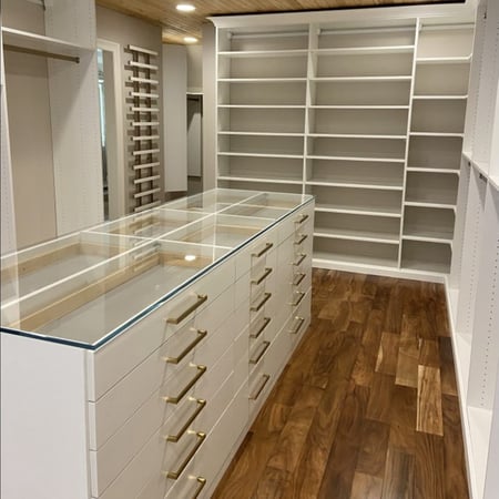White custom closet organization with shoe organization and gold hardware California Closets New Orleans & Gulf Coast