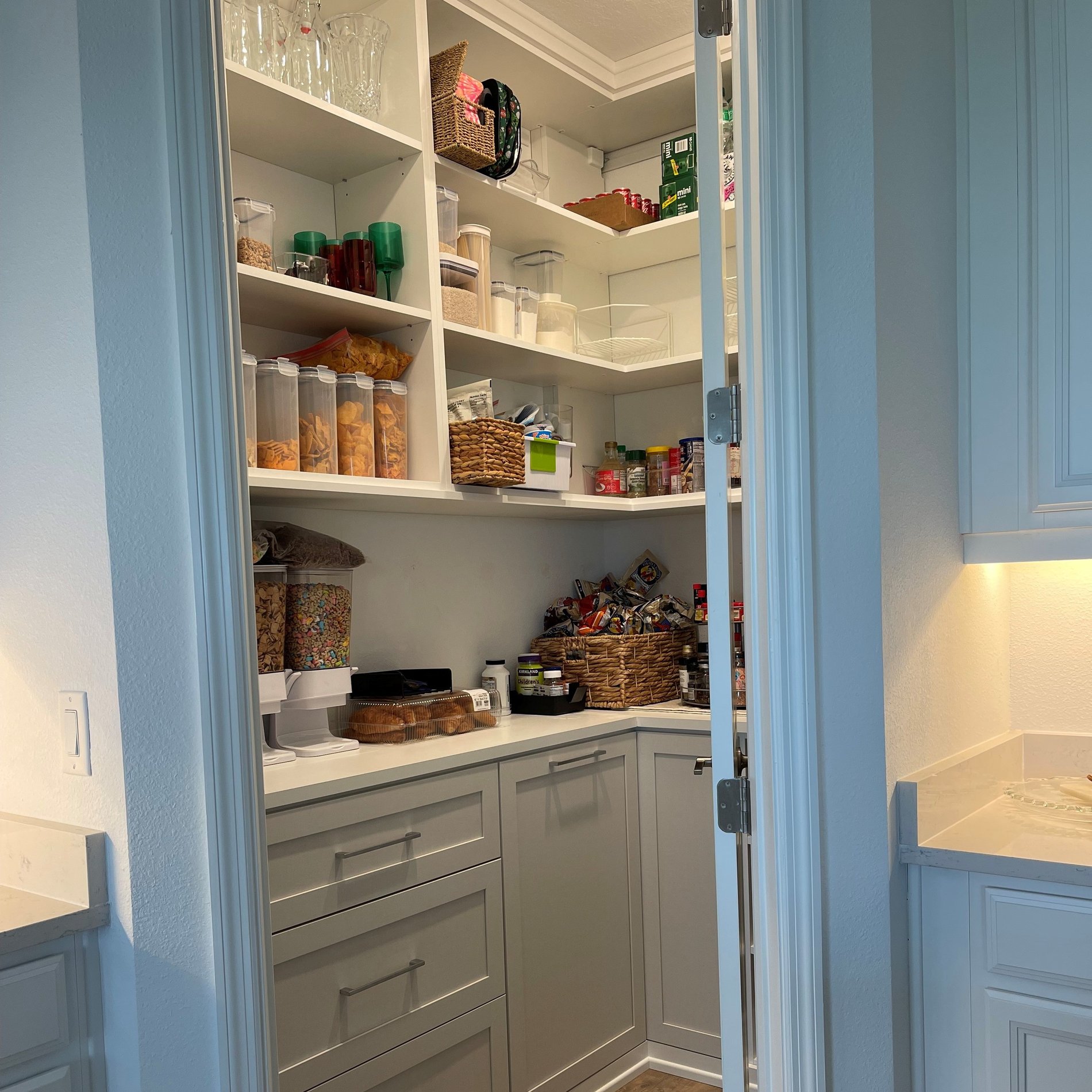 Custom pantry with dove white cabinetry, linen shaker doors, and matte aluminum hardware.