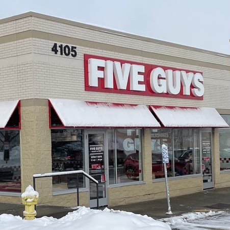 Exterior photograph of the Five Guys restaurant at 4105 Vinewood Lane North in Plymouth, Minnesota.