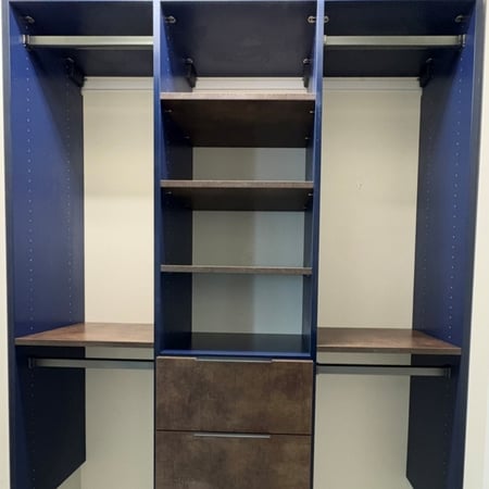 Custom blue wave and Maya Bronze guest closet with matte nickel hardware.