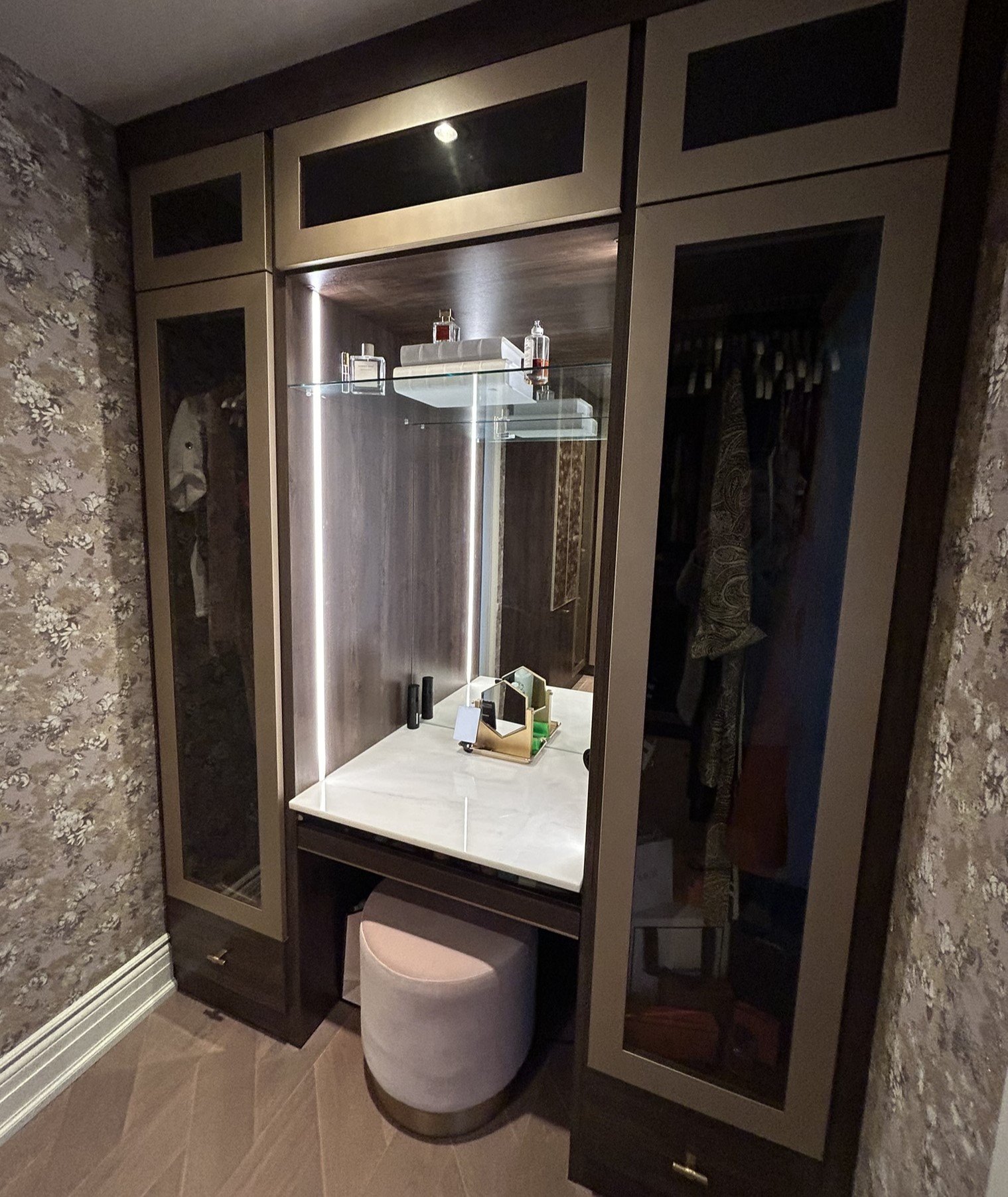 A moody vanity with side lighting and storage