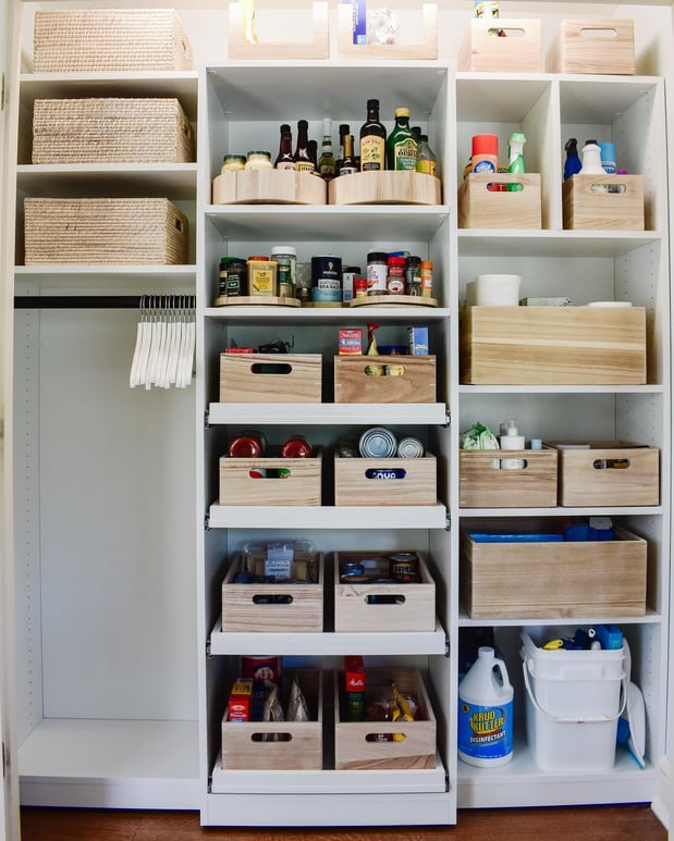 White reach-in pantry with hanging space and cubbies