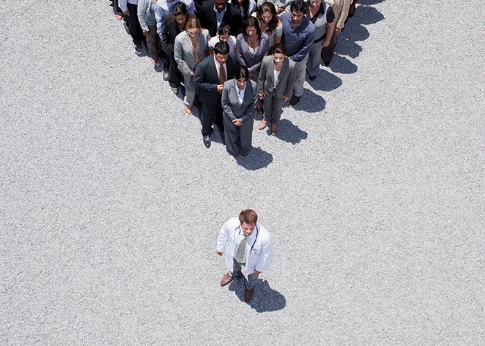 One person standing at the head of a crowd